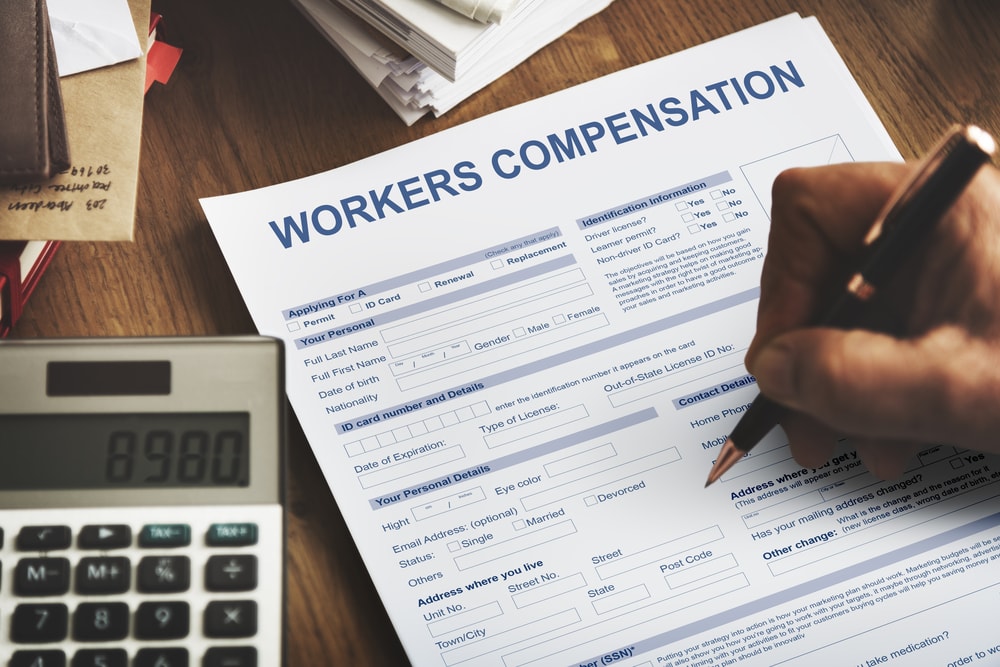 Person filling out workers compensation claim form
