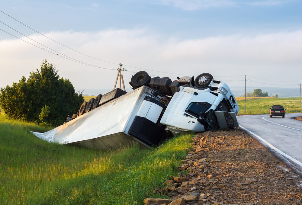 A truck and trailer on the side of the road
