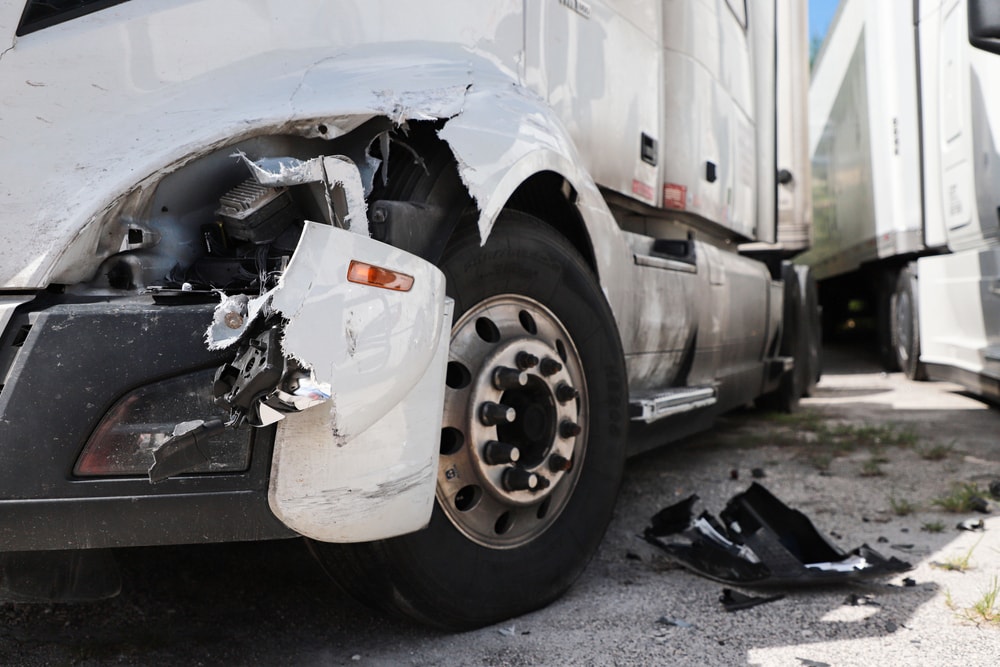 Closeup of white semi truck that has suffered a frontal crash
