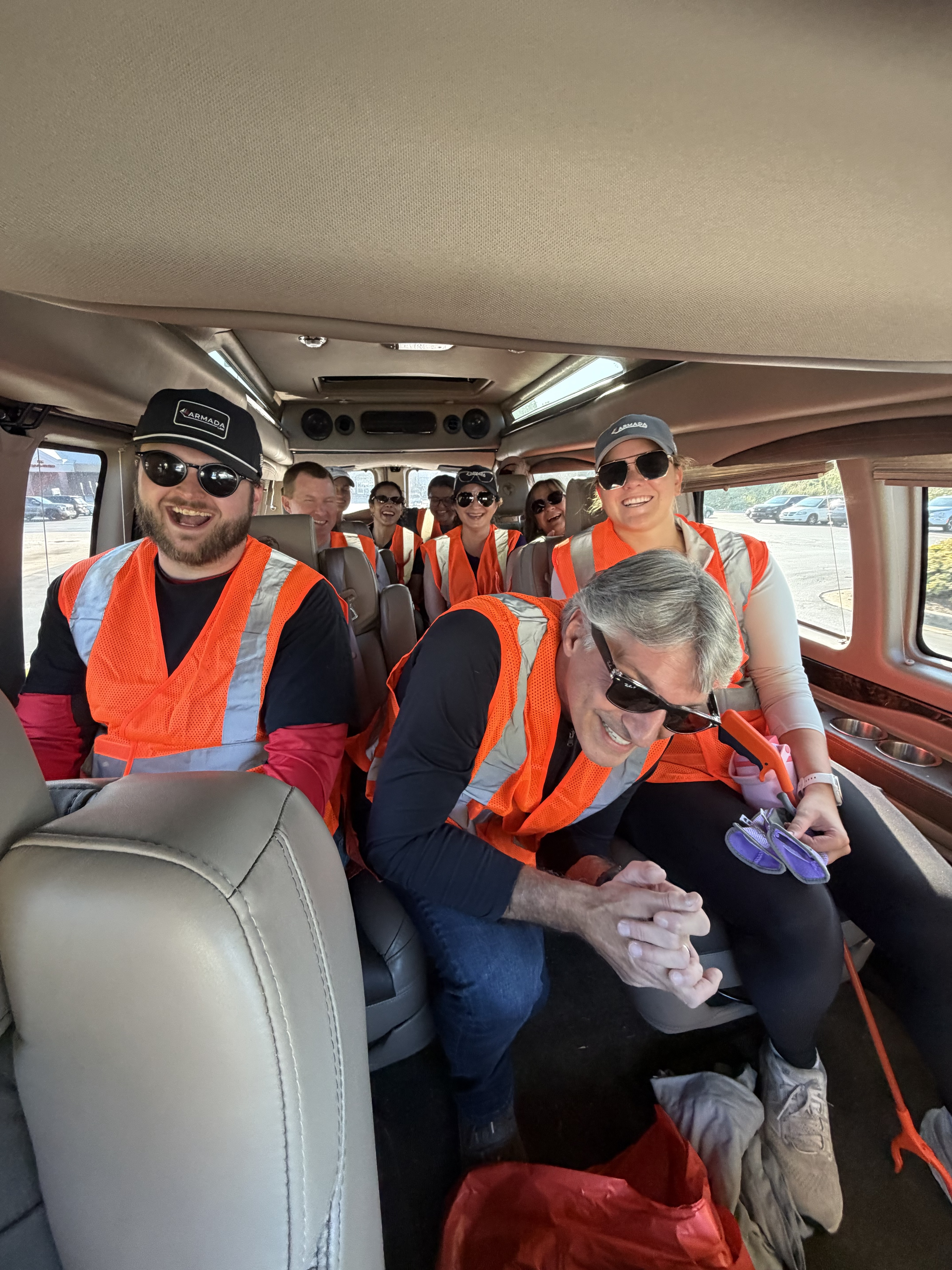 People in a van wear safety vests.