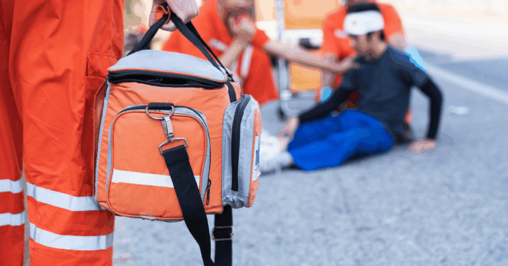 A person in an orange safety vest holds an orange backpack outdoors.