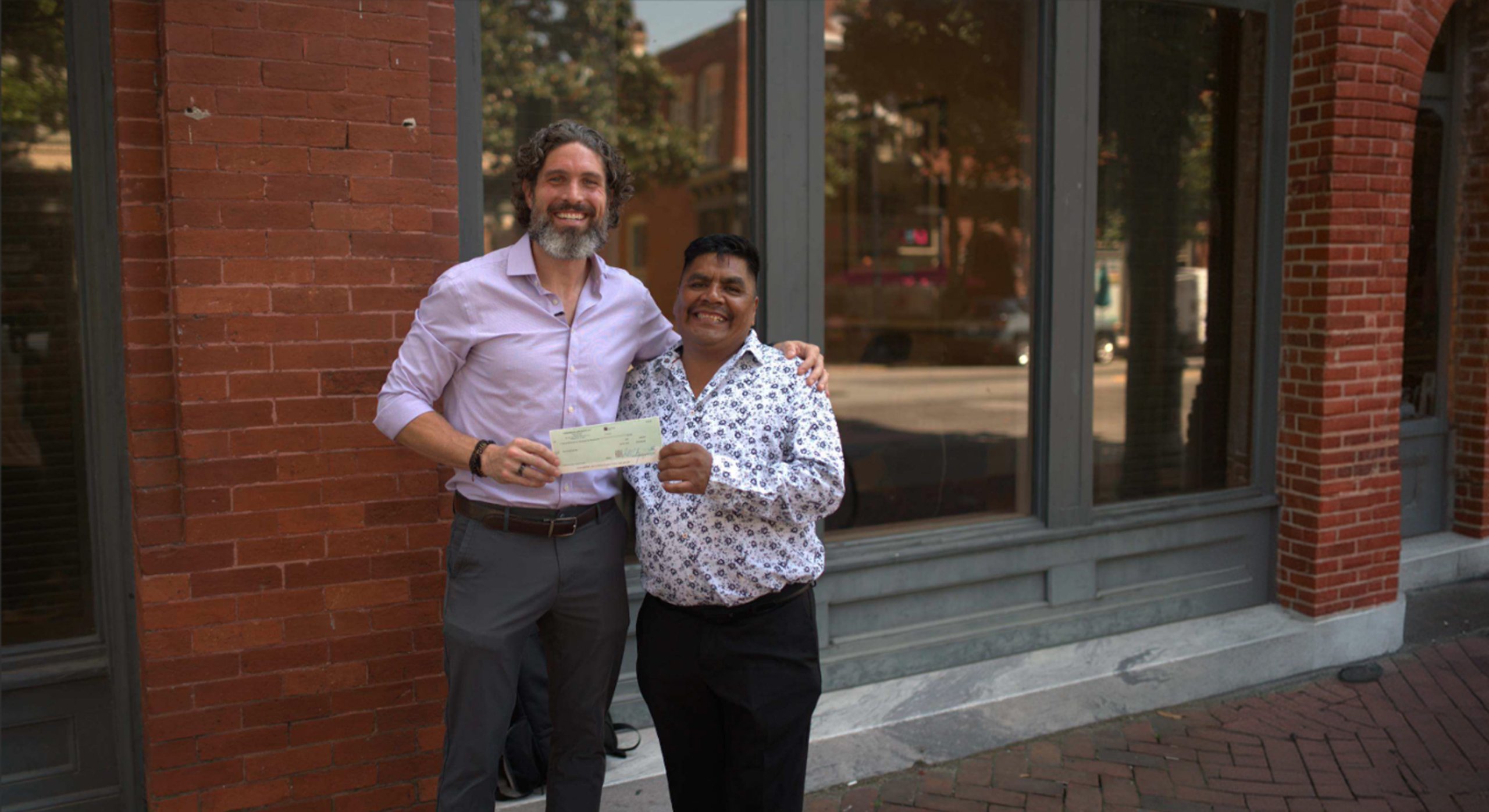 Chris Carsten handing check to client