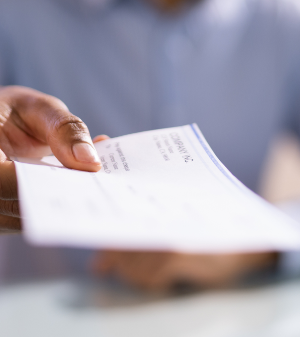 male hand holding a personal injury payment check