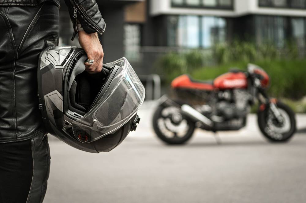 Photo of man with helmet in hand