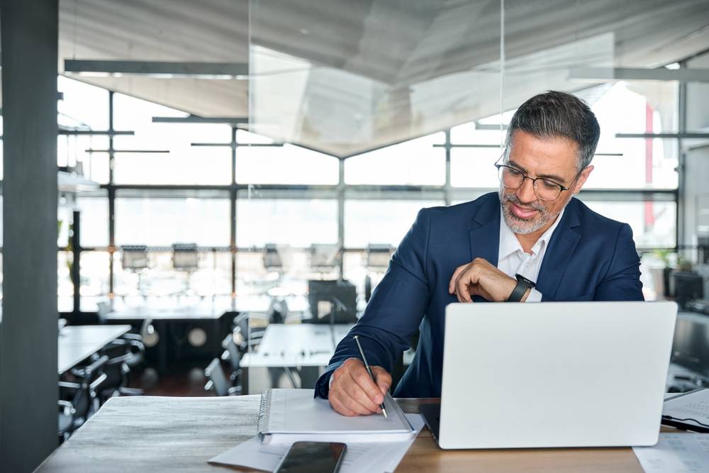 Photo of man writing papers