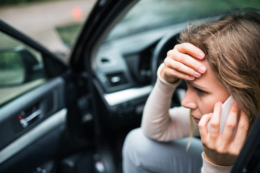 Person calling lawyer after car crash