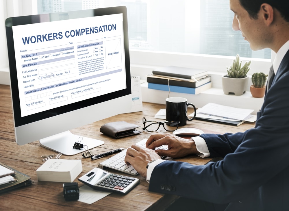 Workers compensation attorney filling out a form on desktop computer