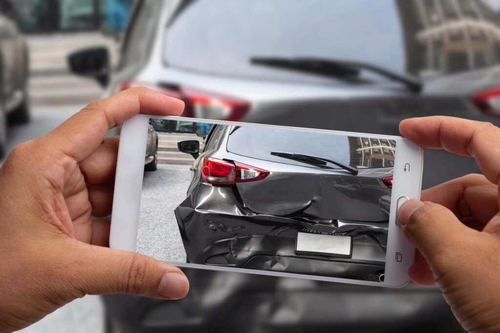 Car insurance agents take pictures of black car accident