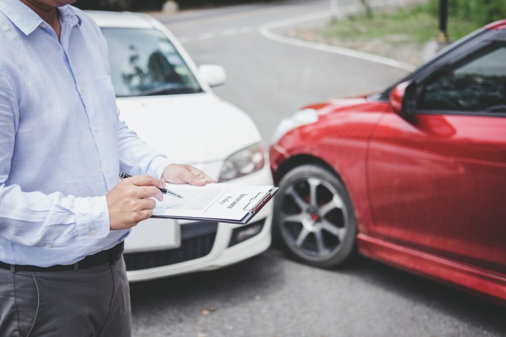 Person checking car insurance paperwork after accident.