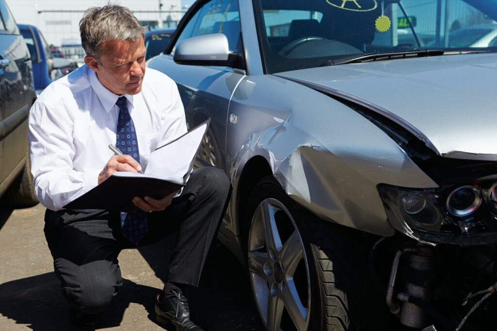 Insurance expert checking car damage after accident