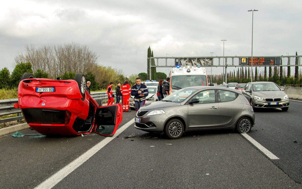 Photo of red car flipped after accident