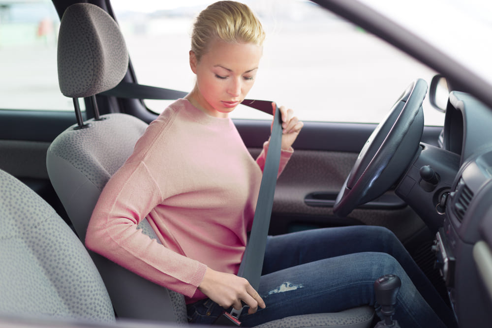 Woman is fixing seatbelt