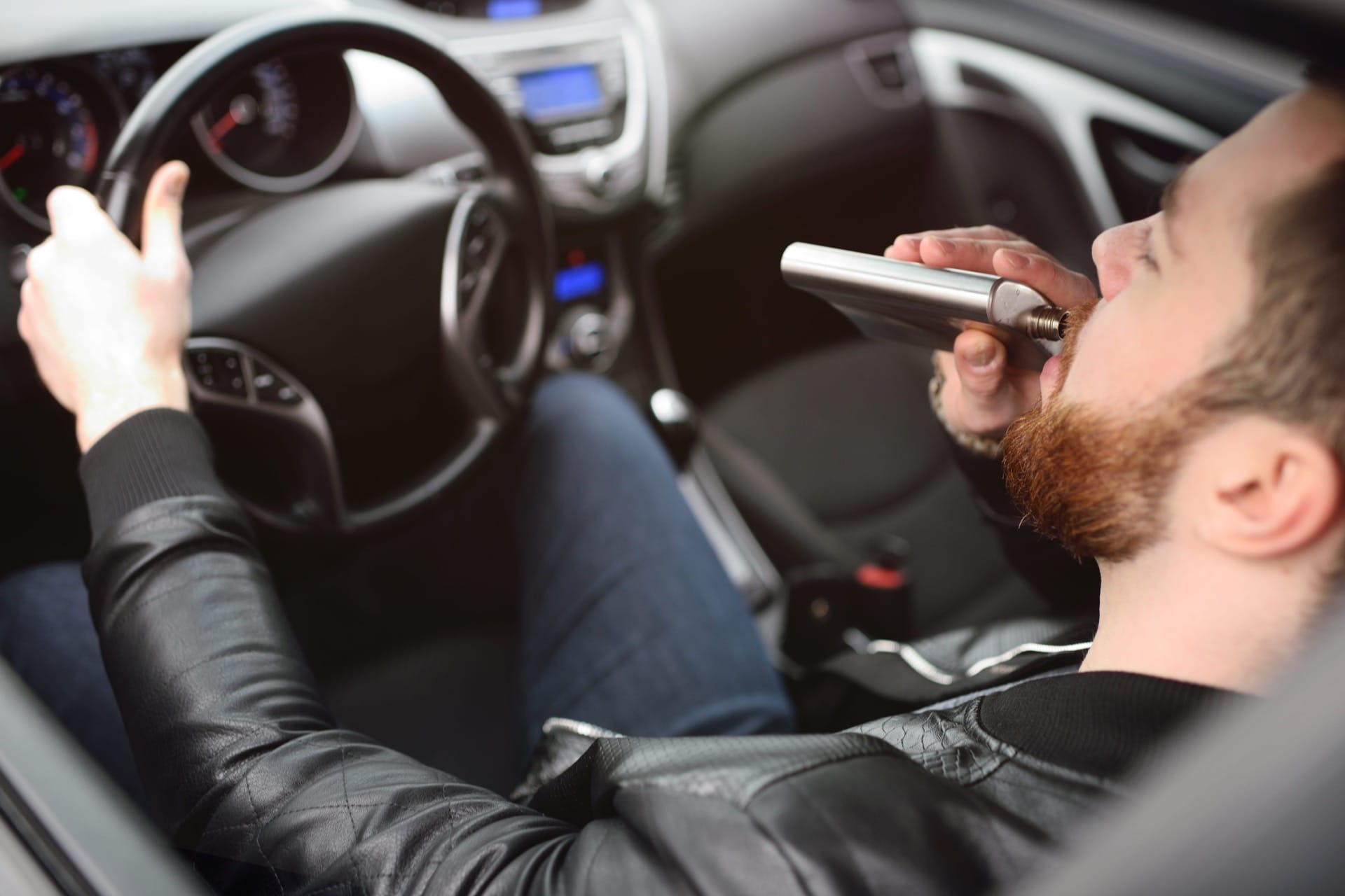 Photo of person drinking and driving