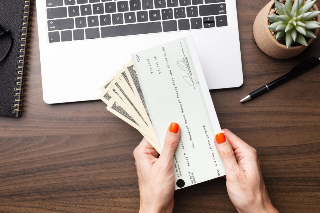 close up of woman holding settlement check