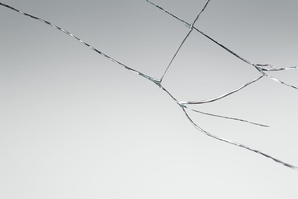 Gray background with cracked glass texture