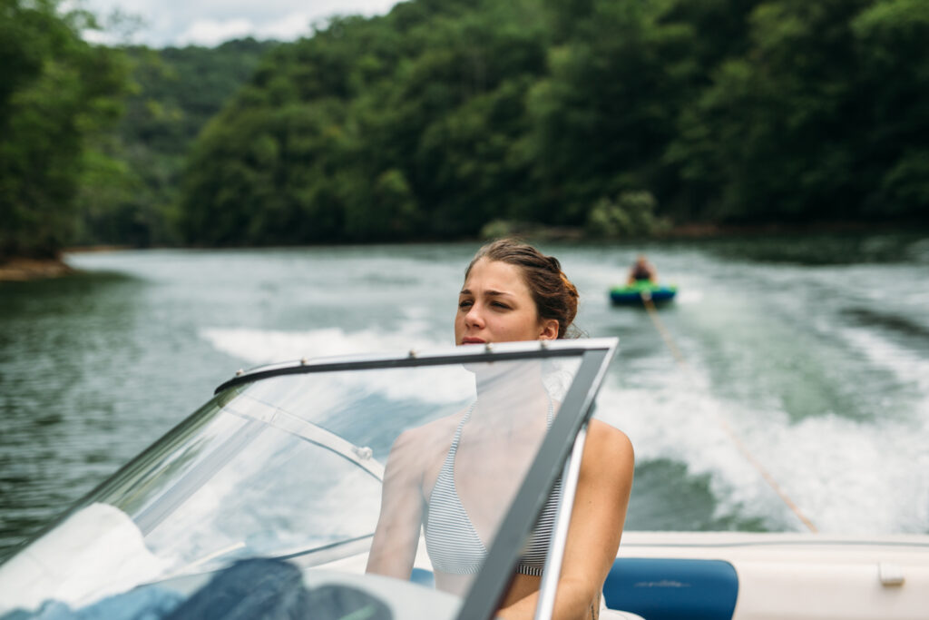 Woman driving a boat on a lake in SC