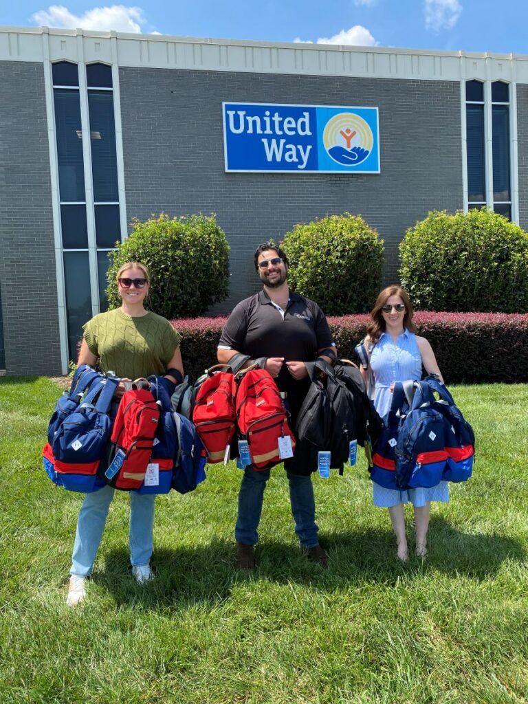 Anslee Woznick, Tim Nicolette and Isabella Martinez Bond with backpacks for donation at United Way of Greenville County